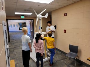 Raafe teaches the kids how the windmill works.